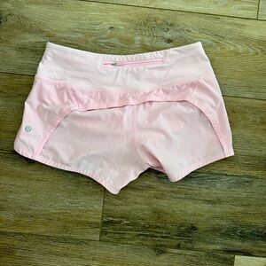 Light pink Lululemon running shorts with zipper
